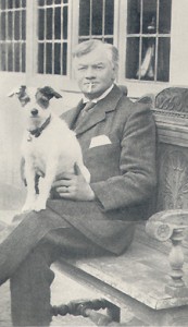 Jerome K Jerome, seated, with his dog